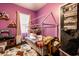 Fun bedroom with purple walls, a unique bed frame, and decorative features, perfect for a room at 71 S 9Th Ave, Beech Grove, IN 46107