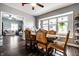 Dining room with wood floors, ample lighting, access to the living room, and a window seat at 71 S 9Th Ave, Beech Grove, IN 46107