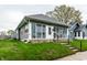 Single-story home with a glass-enclosed porch, a tidy lawn, and a welcoming pathway at 71 S 9Th Ave, Beech Grove, IN 46107