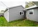View of the home's garage with tidy backyard lawn at 71 S 9Th Ave, Beech Grove, IN 46107