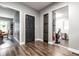 Hallway leading to other rooms with hardwood floors, gray walls, and a dark door at 71 S 9Th Ave, Beech Grove, IN 46107