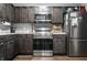Kitchen featuring stainless steel appliances, dark cabinets, and marble countertops at 71 S 9Th Ave, Beech Grove, IN 46107