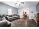 Spacious living room with hardwood floors, gray sofa, a view into the dining area, and natural light at 71 S 9Th Ave, Beech Grove, IN 46107