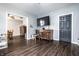 Open-concept living area with dark wood floors, transitional furniture, and a view of the dining area at 71 S 9Th Ave, Beech Grove, IN 46107