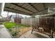 Covered back patio with wooden swing seating surrounded by fenced yard at 71 S 9Th Ave, Beech Grove, IN 46107
