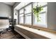 Cozy window seat with storage, hanging plants, and natural light at 71 S 9Th Ave, Beech Grove, IN 46107