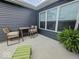 Cozy back patio with seating and a view of the home's siding and windows at 7141 Lillian Pl, Cumberland, IN 46229
