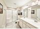 Bathroom with double sink vanity, walk-in shower, and decorative accents at 7141 Lillian Pl, Cumberland, IN 46229