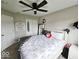 Bedroom with a ceiling fan, cozy carpet, and light filled windows at 7141 Lillian Pl, Cumberland, IN 46229