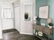 Charming entryway with console table and decorative niche, showcasing the home's stylish interior details at 7141 Lillian Pl, Cumberland, IN 46229