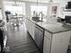 Stylish kitchen island with stainless steel appliances and granite countertops seamlessly connecting to the living area at 7141 Lillian Pl, Cumberland, IN 46229