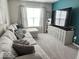 Cozy living room with large sectional couch, plush carpet, and entertainment center, perfect for relaxation at 7141 Lillian Pl, Cumberland, IN 46229