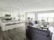 Open-concept living space with kitchen, dining, and living areas, perfect for modern living and entertaining at 7141 Lillian Pl, Cumberland, IN 46229