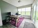 Bright office space with large window, sliding glass doors, and rustic wood desk at 7141 Lillian Pl, Cumberland, IN 46229