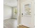 Bright entryway with wood-look floors, leading to a spacious area with natural light from the window at 7277 Governors Row, Avon, IN 46123
