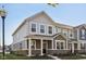 Stylish two-story home featuring mixed siding, a covered porch, and professional landscaping at 7277 Governors Row, Avon, IN 46123