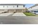 Townhouse exterior with two car garage, driveway, and sidewalk at 7277 Governors Row, Avon, IN 46123