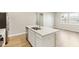 Bright kitchen featuring a kitchen island with sink and white cabinets at 7277 Governors Row, Avon, IN 46123