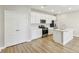 Modern kitchen features stainless steel appliances, white cabinets, and an island with a sink at 7277 Governors Row, Avon, IN 46123