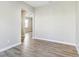 Bright, open living room with wood-look flooring and a view into another room at 7277 Governors Row, Avon, IN 46123