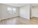 Spacious living room with wood-look floors, neutral walls, and staircase access at 7277 Governors Row, Avon, IN 46123