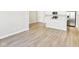 Open-concept living room with wood-look floors, seamlessly connected to the modern kitchen at 7277 Governors Row, Avon, IN 46123