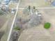 A beautiful aerial view of the property showcasing the house, surrounding land, and nearby pond at 7561 N Hall School Rd, Monrovia, IN 46157