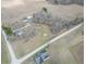 An aerial view of the property, showing the home, outbuildings, yard, farmland and the quiet countryside setting at 7561 N Hall School Rd, Monrovia, IN 46157