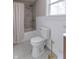 Well-lit bathroom with stylish tile flooring, tub-shower, and white wainscoting at 7561 N Hall School Rd, Monrovia, IN 46157