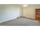 Spacious bedroom with a ceiling fan, built-in bookcase, and patterned carpet at 7561 N Hall School Rd, Monrovia, IN 46157