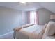 Bedroom featuring a cozy bed with neutral bedding, soft pink curtains, and a sloped ceiling at 7561 N Hall School Rd, Monrovia, IN 46157