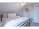 Bedroom with neutral bedding, sloped ceiling, and tree wall decor at 7561 N Hall School Rd, Monrovia, IN 46157