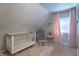 Charming Bedroom with a white crib, glider, and pink accents creates a cozy space at 7561 N Hall School Rd, Monrovia, IN 46157