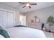 Bright bedroom featuring neutral walls, ceiling fan, and a stylish light wood dresser with decorative accents at 7561 N Hall School Rd, Monrovia, IN 46157