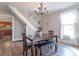 Charming dining room with a modern light fixture, a wooden table with seating for four, and updated floors at 7561 N Hall School Rd, Monrovia, IN 46157