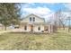 Two-story home featuring a welcoming front porch and well-maintained landscaping under a sky with scattered clouds at 7561 N Hall School Rd, Monrovia, IN 46157