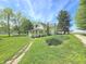 Quaint two-story home featuring a covered porch and well-maintained yard with beautiful flower beds at 7561 N Hall School Rd, Monrovia, IN 46157