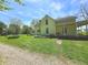 Charming two-story home with a covered porch featuring a swing, surrounded by lush landscaping at 7561 N Hall School Rd, Monrovia, IN 46157
