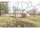 A view of a two-story home with a covered porch, lawn, and mature trees at 7561 N Hall School Rd, Monrovia, IN 46157