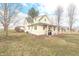 A two-story home featuring a covered porch with grill, lawn, and mature trees at 7561 N Hall School Rd, Monrovia, IN 46157