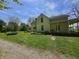Side view of a yellow two-story home featuring a covered front porch with swing at 7561 N Hall School Rd, Monrovia, IN 46157