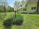 Close up of a garden and the side of a yellow two-story home at 7561 N Hall School Rd, Monrovia, IN 46157