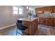 A well-lit kitchen with stainless steel appliances, wood cabinets, and a butcher block island with bar stool seating at 7561 N Hall School Rd, Monrovia, IN 46157