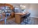 Updated kitchen features modern island with seating, wood cabinets and stainless appliances at 7561 N Hall School Rd, Monrovia, IN 46157