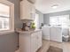 Bright laundry room features new appliances, stylish cabinets, and convenient countertop space at 7561 N Hall School Rd, Monrovia, IN 46157