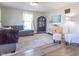 Sun-filled living room with hardwood floors, a gray sectional, a cabinet and large window with modern decor at 7561 N Hall School Rd, Monrovia, IN 46157