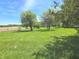 Spacious and well-maintained front yard dotted with mature trees on a sunny day at 7561 N Hall School Rd, Monrovia, IN 46157