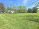 Spacious front yard showcasing the home and mature trees on a sunny day at 7561 N Hall School Rd, Monrovia, IN 46157