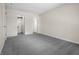 Bedroom with neutral walls and plush gray carpeting, showcasing multiple entryways at 7652 Wood Stream Dr, Indianapolis, IN 46239