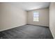 Bedroom with plush gray carpeting and a window offering abundant natural light at 7652 Wood Stream Dr, Indianapolis, IN 46239